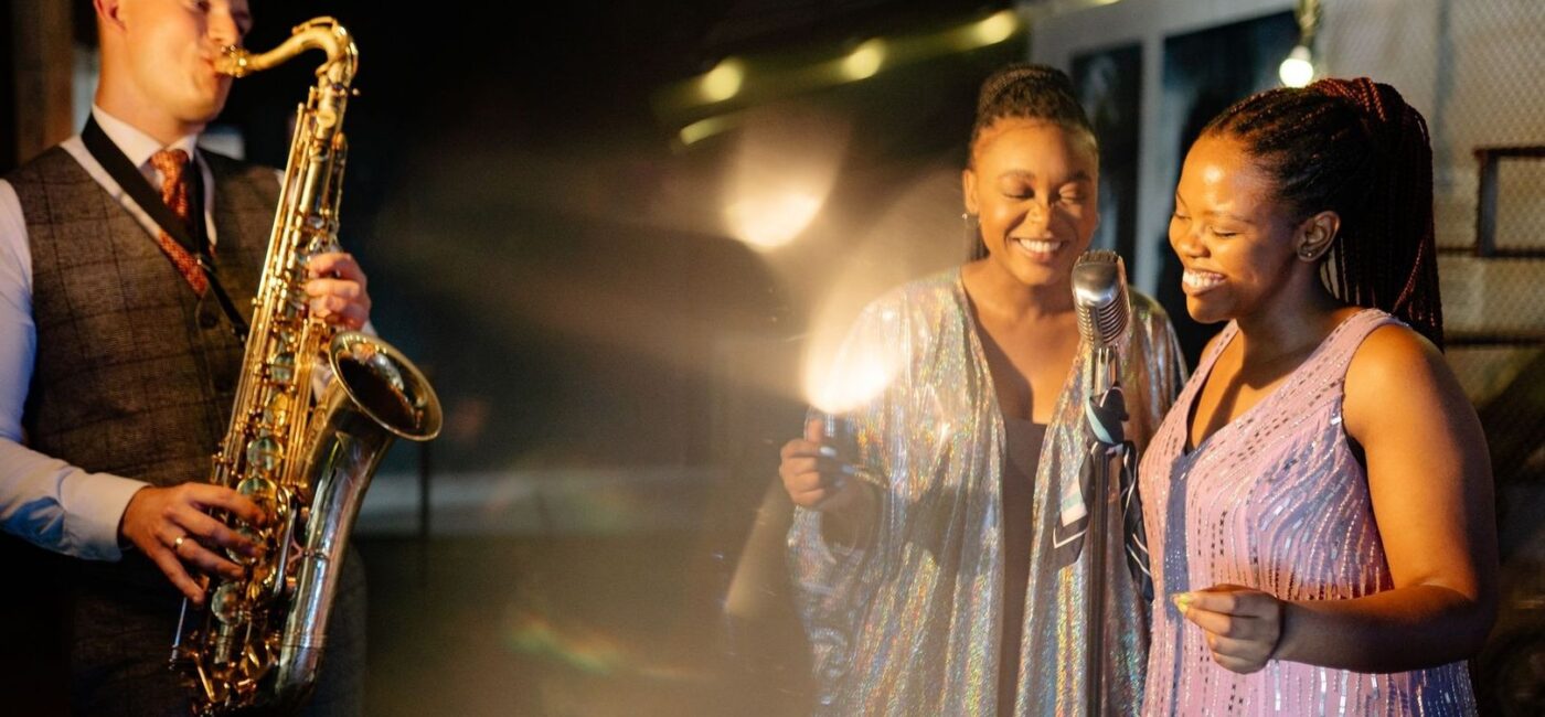 Liveband mit Saxofon und zwei Sängerinnen bei einem Soul-Auftritt